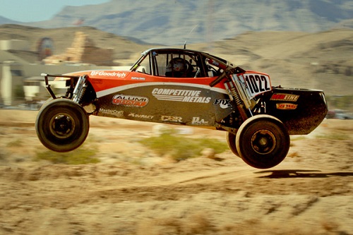 <img src= "class_10_buggy.jpg" alt= "red and black class 10 Alumi Craft buggy catches air as is competes in another desert race" />