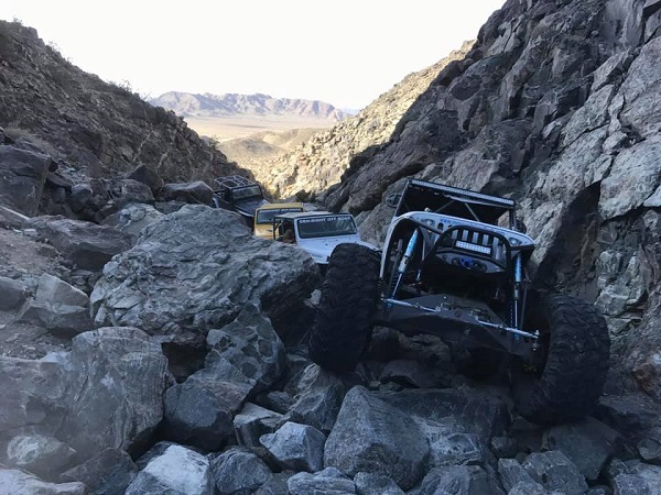 <img src="ny2019.jpg" alt= "a group of off road vehicles make their way up a rocky trail together" />