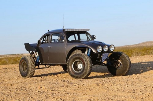 <img src= "baja_bug.jpg" alt= "a modern day black baja bug sits in the dirt"