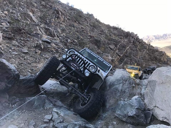 <img src="newyearstrailrun.jpg" alt= "a jeep in trouble gets some help from a winch line" />